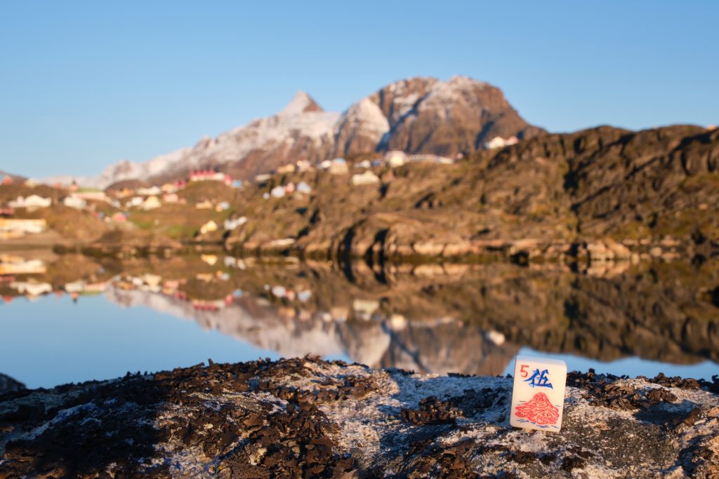 A character tile from the custom Mahjong set for Greenland in front of Paaraasuk Bay and Sisimiut's iconic mountain - Nasaasaaq
