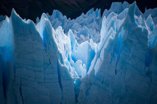 Close view of jagged blue glacier ice in Los Glaciares National Park.