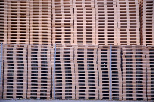 Close-up of stacked wooden pallets or crates arranged in rows.